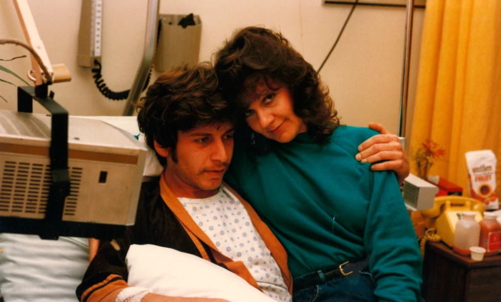 Ward 5B nurse hugging and caring for a patient with AIDS